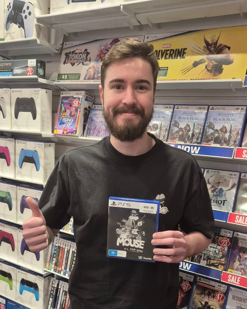 Holding a physical PlayStation 5 copy of MOUSE: P.I. For Hire in a retail store